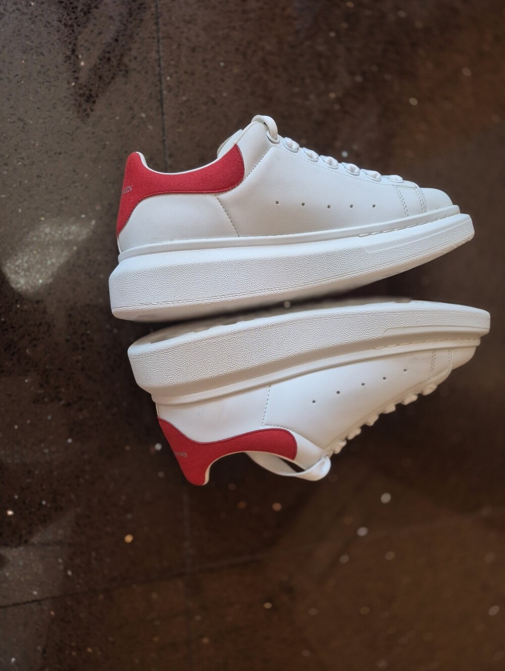 Alexander Mqueen White Leather Sneakers with Red Heel Accent .